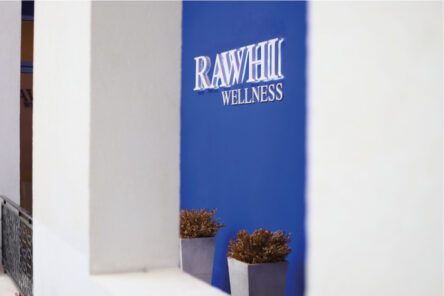 Rawhi wellness logo on a blue wall at Ayla Marina village