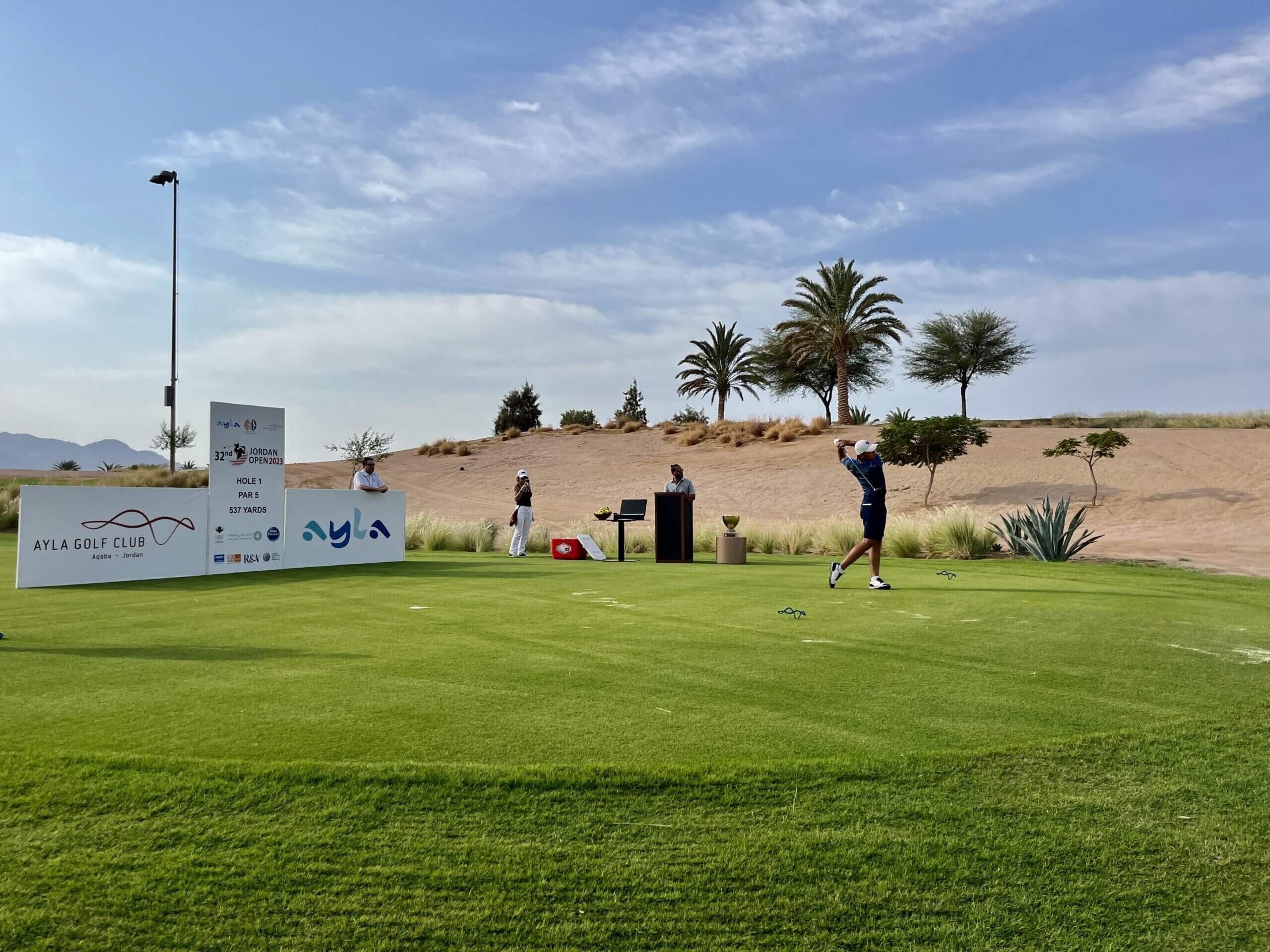 Golf player in action at Ayla Golf Club.